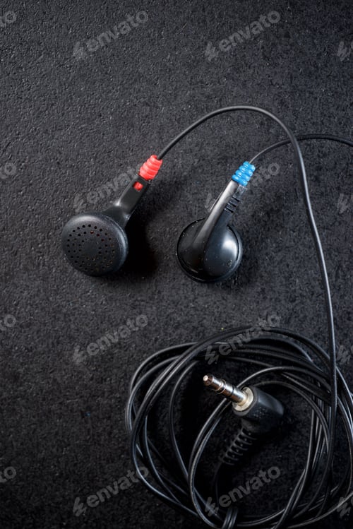 Preview: Small Headphones On A Black Table.