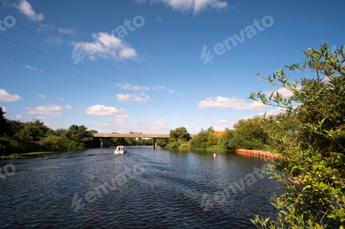 Preview: Small White Motor Boat Cruising On A Wide River