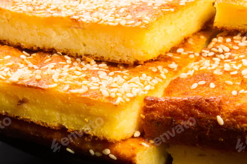 Preview: Slice Of Cheesecake With Sesame Seeds On A Black Background