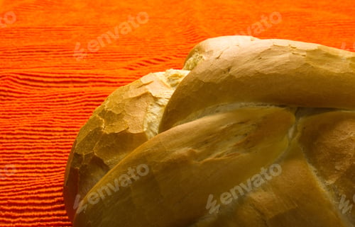 Preview: Fresh Braided Loaf Of White Wheat Bread On An Orange Napkin