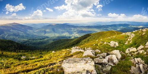 Preview: Mountain Panorama Landscape. Valley With Stones In Grass On Top Of The Hillside Of Mountain Range