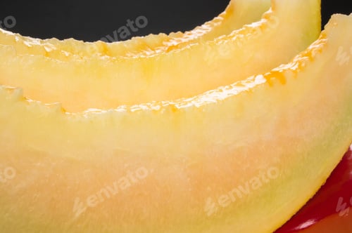 Preview: Slices Of Ripe Juicy Melon In Red Plate On Black Background