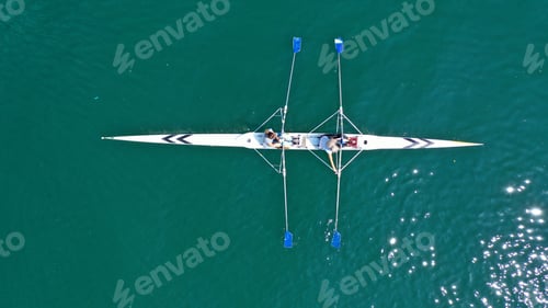 Preview: Aerial Drone Bird'S Eye View Of Sport Canoe Operated By 2 Young Women In Turquoise Clear Waters