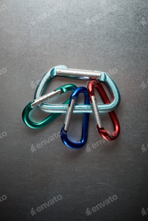 Preview: Small Carabiners On A Metal Table.