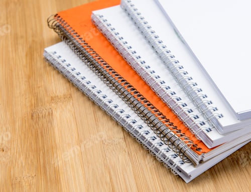 Preview: Stack Of White And Orange Personal Office Notebooks