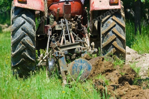 Preview: Red Tractor Plowing In An Orchard