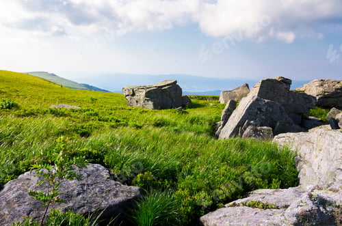 Preview: Beautiful Morning Scenery In Mountains. Rocks Among The Grass. Cloudy Sky Over The Mountain Ridge