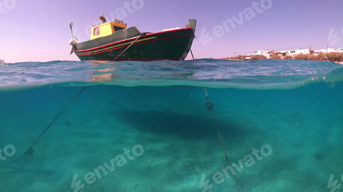 Preview: Above And Below Underwater Photo Of Colourful Fishing Boat In Turquoise Clear Greek Island Sea
