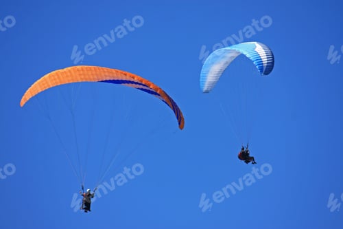 Preview: Paragliders In Blue Sky