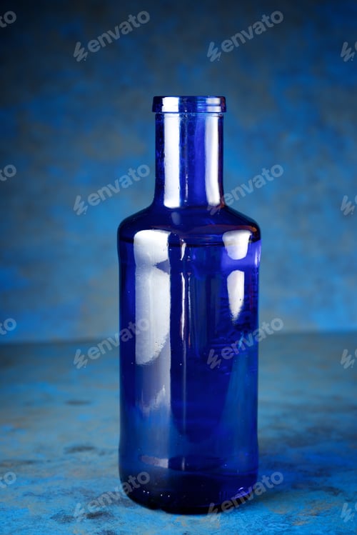 Preview: Blue Glass Bottle On A Table.
