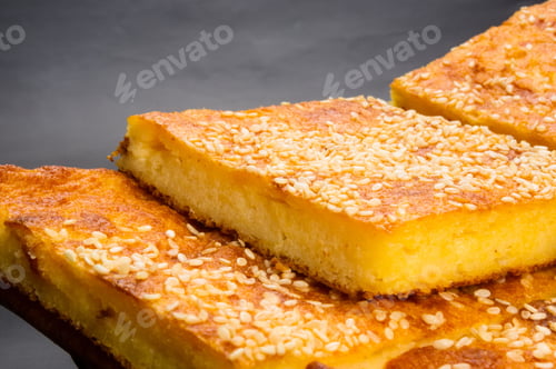 Preview: Slice Of Cheesecake With Sesame Seeds On A Black Background