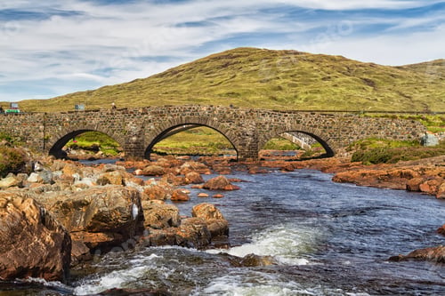 Preview: Old Vintage Brick Bridge Crossing River In Sligachan, Isle Of Skye, Scotland With Scottish