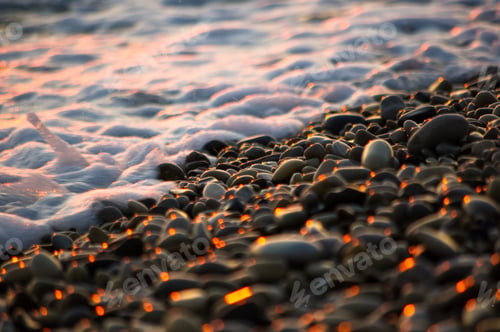 Preview: Pebble Stones On The Sea Beach On A Warm Summer Day, The Rolling Waves Of The Blue Sea With White