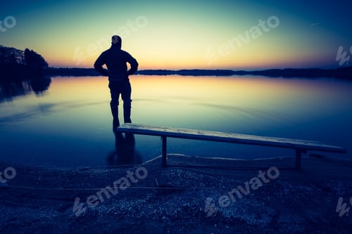 Preview: Man In Lake Water At Sunset. Beautiful Sunset With Man Silhouette