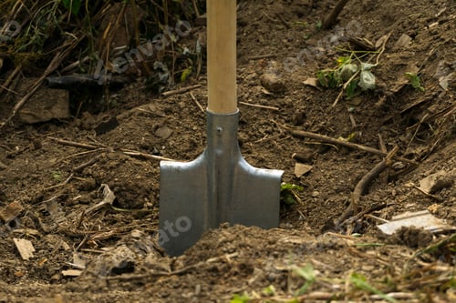 Preview: Simple Shovel With A Wooden Handle Is Stuck In A Dry Ground In An Unfinished Pit