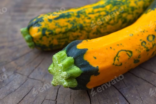 Preview: Unusual Green-Orange Zucchini On An Old Wooden Background