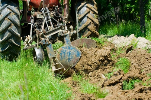 Preview: Red Tractor Plowing In An Orchard