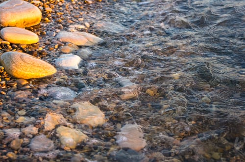 Preview: Sea Pebble Beach With Multicoloured Stones, Transparent Waves With Foam, On A Warm Evening