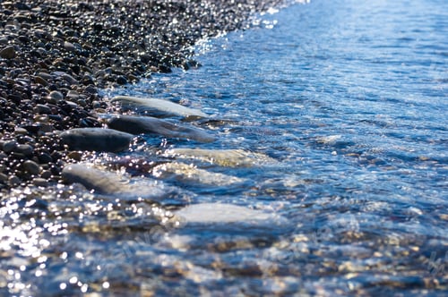 Preview: Sea Pebble Beach With Multicoloured Stones, Transparent Waves With Foam, On A Warm Summer Day