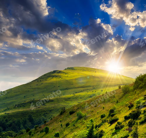 Preview: Slope Of Mountain Range With Coniferous Forest And Village At Sunset