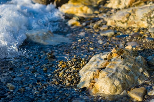 Preview: Pebble Stones On The Sea Beach On A Warm Summer Day, The Rolling Waves Of The Blue Sea With White