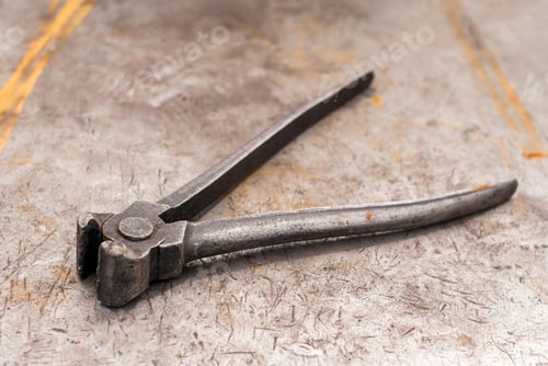 Preview: Old Pincers Lie On A Rusty Shabby Metal Surface