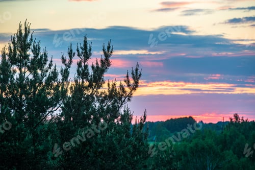 Preview: Dramatic Red Sunset Colors In The Sky Above Trees And Fields. Summer Sunset In Latvia