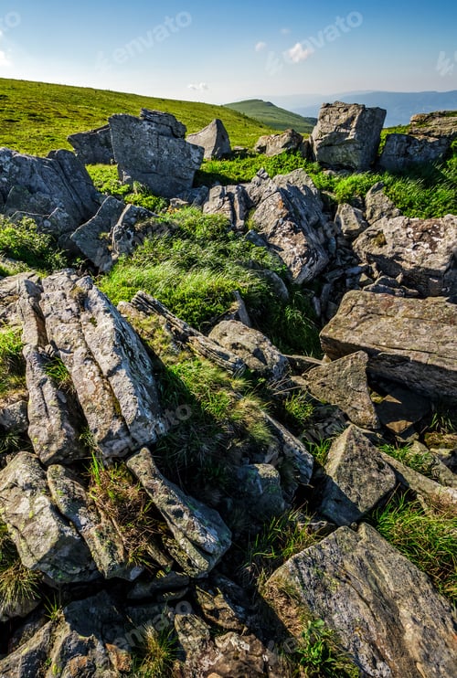Preview: Grassy Meadow With Giant Boulders On The Slope. Mountain Ridge On A Beautiful Sunny Summer Day