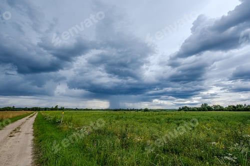 Preview: Storm Rain Clouds Forming Over The Countryside Fields In Green Summer Evening