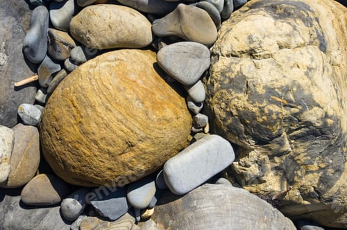 Preview: Boulders And Colorful Pebbles On The Beach On A Warm Summer Day