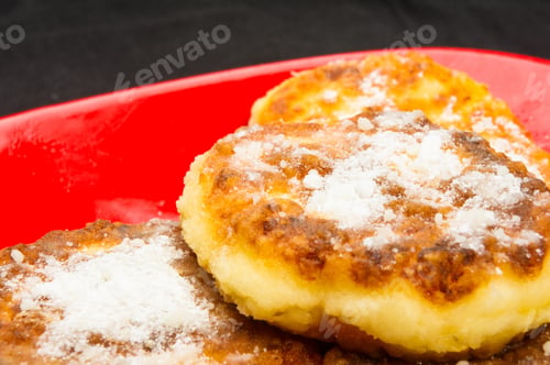Preview: Red Plate Of Pancakes In Powdered Sugar On Black Background