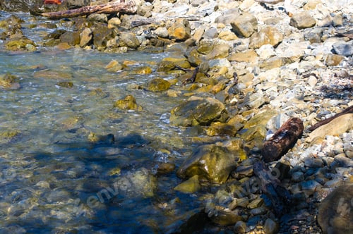 Preview: Rocky Sea Shore With Pebble Beach, Transparent Waves With Foam, On A Warm Summer Day