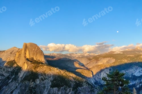 Preview: A Panoramic View Of Half Dome And Yosemite Valley. Golden Light From The Sunset Is Cast Upon The