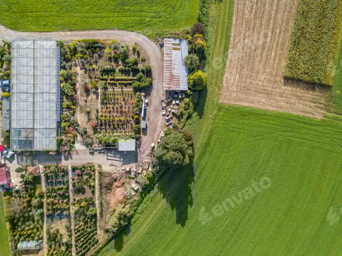 Preview: Aerial View Of Greenhouse And Vegetables Fields In Small Farming Area. Garden Center From Above.