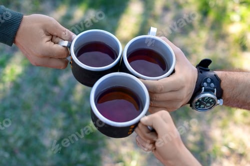 Preview: Top View Of A Three Hands With A Cups Of Tea. Picnic Of A Friends Outdoor.
