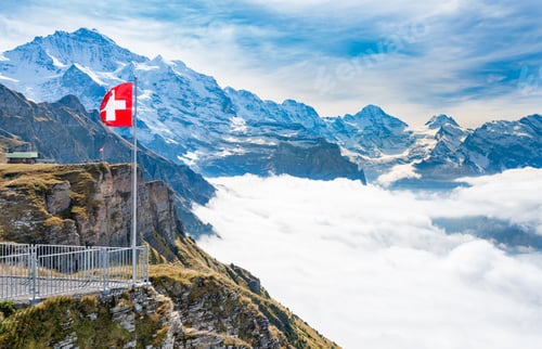 Preview: Red Swiss Flag At Mannilichen Top Station Above Grindelwald And Wengen. Switzerland.
