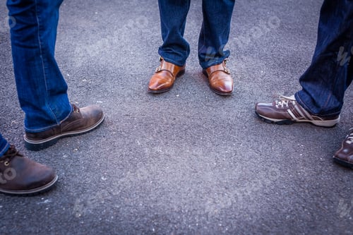 Preview: Close Up Of Legs And Feet Of Three Friends Standing On A Street And Talking