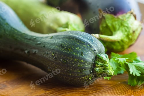 Preview: Still Life - Fresh Whole Zucchini, Eggplant And Parsley On A Wooden Board, Close Up