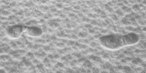 Preview: A Couple Of Human Footsteps Over Frozen Snow