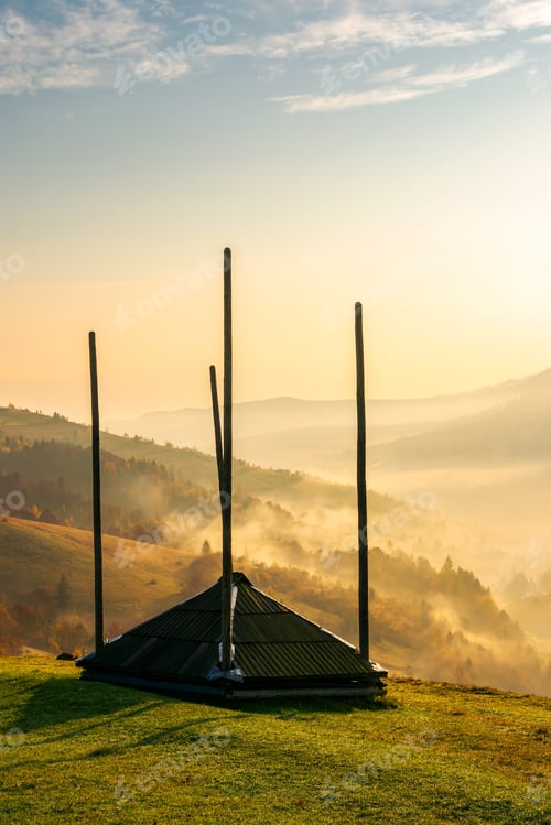 Preview: Empty Hay Barrack On A Hill Side. Beautiful Foggy Scenery In The Distant Valley. Rural Lifestyle