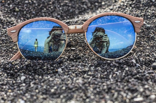 Preview: Close Up Of Sun Glasses On Black Stony Background Reflecting Photographer