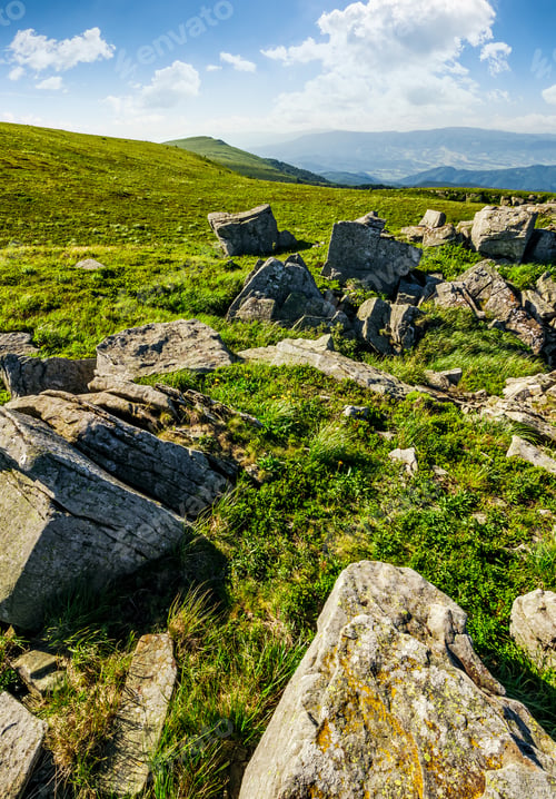 Preview: Grassy Meadow With Giant Boulders On The Slope. Mountain Ridge On A Beautiful Sunny Summer Day