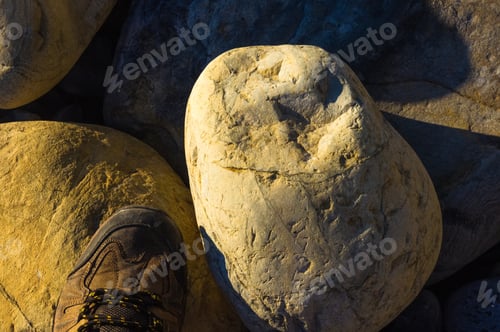 Preview: Hiking Boots, Boulders And Colorful Pebbles On The Beach