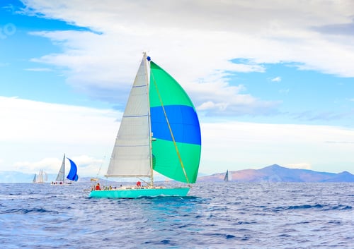 Preview: Sailing Boat With A Green - Blue Spinnaker During A Regatta Out Of Poros Island In Greece