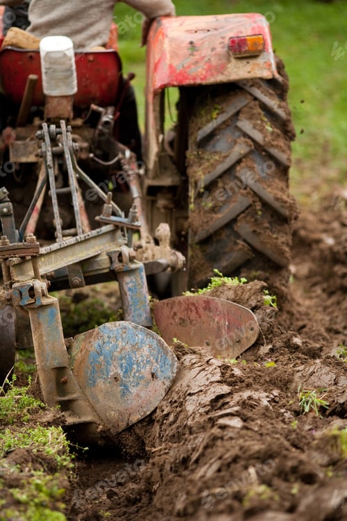 Preview: Close Up Of The Rear End Of A Tractor While Plowing, Some Motion Blur Present