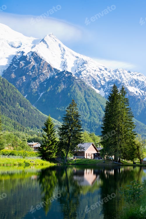 Preview: Mountains And Trees Reflection In The Water Of Alpine Lake In Chamonix - France.