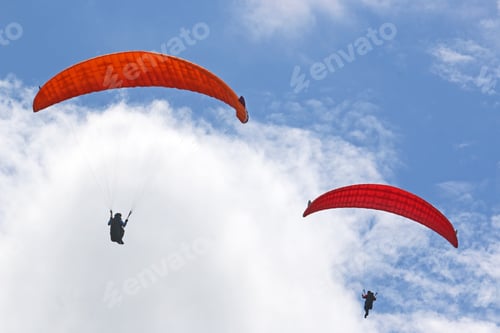 Preview: Paragliders Flying In A Blue Sky