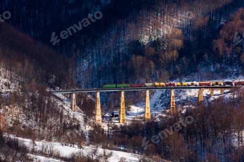 Preview: Winter Rail Road Transportation In Mountains. Freight Train With Colorful Carriage On The Old