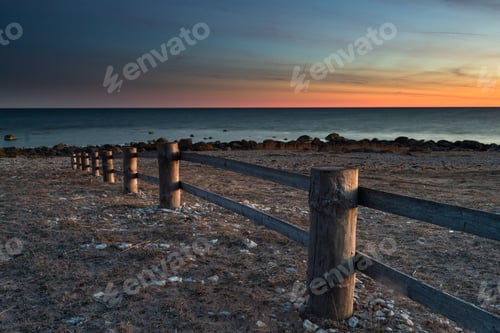 Preview: Wooden Fence Near The Sea At Sunset