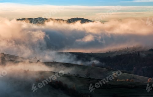 Preview: Clouds And Fog Rising Over Countryside. Rural Fields On Hills In Gorgeous Autumn Sunrise